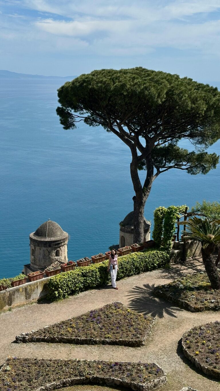 A picturesque garden on the Amalfi Coast with a view of the Mediterranean Sea.